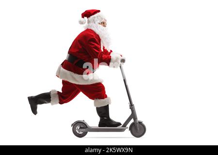 Full length profile shot of Santa Claus riding an electric scooter isolated on white background Stock Photo