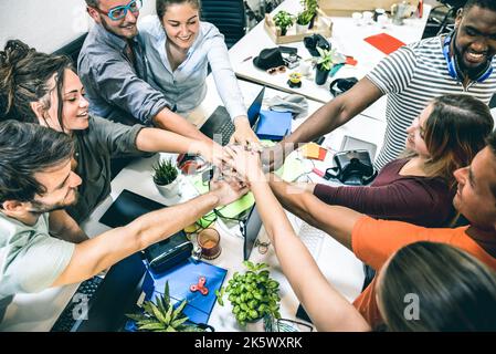 Young employee startup workers group stacking hands at urban studio during entrepreneurship brainstorming project - Business concept of human resource Stock Photo
