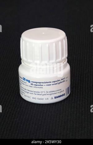 Photo of plastic container of omeprazole capsules ('omeprazol' in dutch), produced by Sandoz Stock Photo