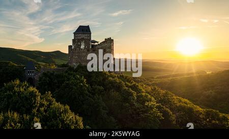 Renewed historical monument in Hungary Mountains. Aerial landscape photo about a medieval castle ruins near by Holloko town. Panoramic landscape photo Stock Photo