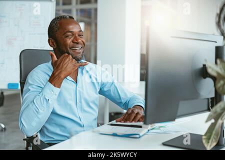 African businessman using sign language while talking online with client sitting in office Stock Photo