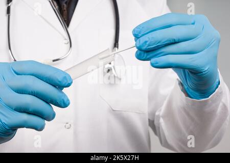 Close up of handling a Corona smear test in a medical laboratory Stock Photo