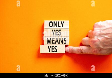 Only yes means yes symbol. Concept words Only yes means yes on wooden blocks on a beautiful orange table orange background. Businessman hand. Business Stock Photo