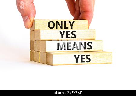 Only yes means yes symbol. Concept words Only yes means yes on wooden blocks on a beautiful white table white background. Businessman hand. Business, Stock Photo