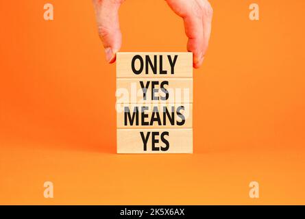 Only yes means yes symbol. Concept words Only yes means yes on wooden blocks on a beautiful orange table orange background. Businessman hand. Business Stock Photo