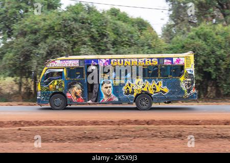 A bus with custom paintwork driving along Ngong road near the junction with Oloolua Close. Many buses in Nairobi have custom paintwork, a wide range o Stock Photo