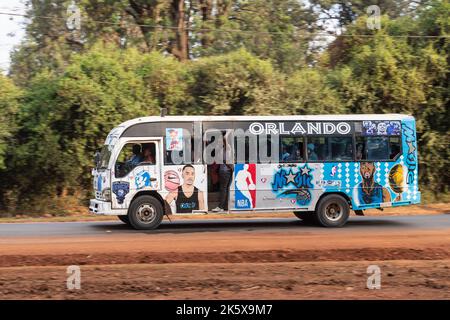 A bus with custom paintwork driving along Ngong road near the junction with Oloolua Close. Many buses in Nairobi have custom paintwork, a wide range o Stock Photo