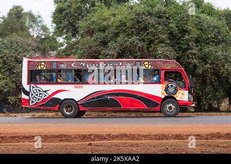 A bus with custom paintwork driving along Ngong road near the junction with Oloolua Close. Many buses in Nairobi have custom paintwork, a wide range o Stock Photo