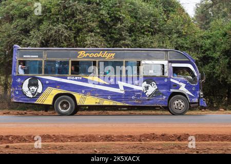 A bus with custom paintwork driving along Ngong road near the junction with Oloolua Close. Many buses in Nairobi have custom paintwork, a wide range o Stock Photo