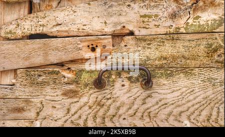old wooden door with a rusty iron handle Stock Photo
