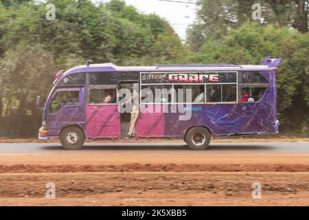 A bus with custom paintwork driving along Ngong road near the junction with Oloolua Close. Many buses in Nairobi have custom paintwork, a wide range o Stock Photo