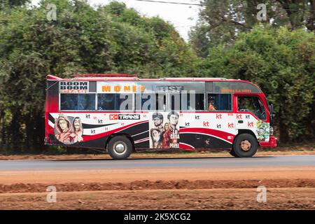 A bus with custom paintwork driving along Ngong road near the junction with Oloolua Close. Many buses in Nairobi have custom paintwork, a wide range o Stock Photo