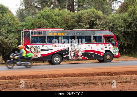 A bus with custom paintwork driving along Ngong road near the junction with Oloolua Close. Many buses in Nairobi have custom paintwork, a wide range o Stock Photo