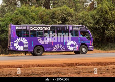 A bus with custom paintwork driving along Ngong road near the junction with Oloolua Close. Many buses in Nairobi have custom paintwork, a wide range o Stock Photo