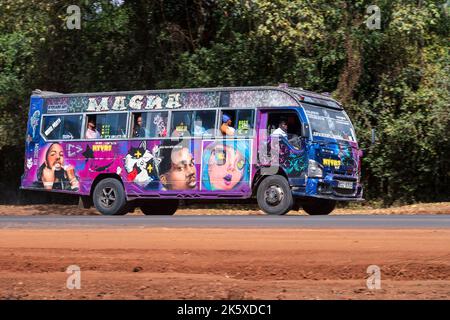 A bus with custom paintwork driving along Ngong road near the junction with Oloolua Close. Many buses in Nairobi have custom paintwork, a wide range o Stock Photo