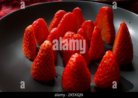 Strawberries on a black plate Stock Photo