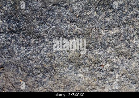 Old Weathered Natural Stone Texture Ancient grungy wall - Sandstone surface background Texture of natural rock granite , magmatic structure with quart Stock Photo