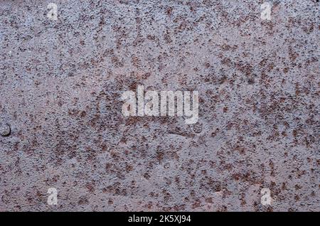 Old rusty sheet of iron. Close-up. Background. Texture. An old ferrous sheet is covered by disseminations of blight. Stock Photo