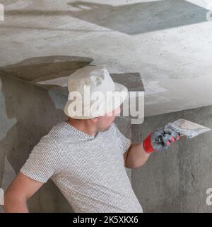 Application of lime plaster on the ceiling, repair work with environmentally friendly lime, overhaul of the room. Stock Photo