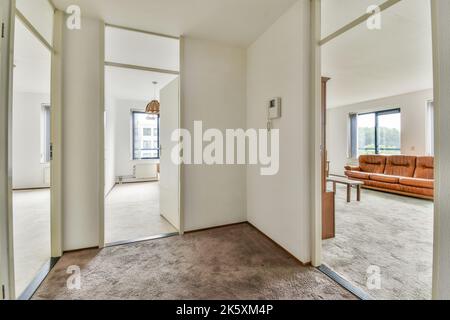 Interior of narrow corridor with telephone in daylight Stock Photo