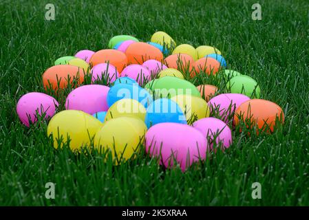 Colorful Plastic Easter Eggs on Green Grass Stock Photo