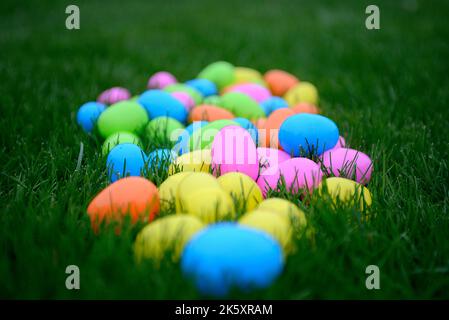 Colorful Plastic Easter Eggs on Green Grass, Selective Focus Stock Photo