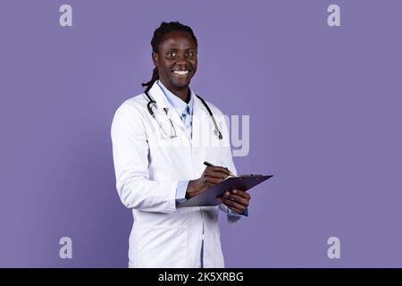 Portrait of friendly young african american doctor on purple Stock Photo