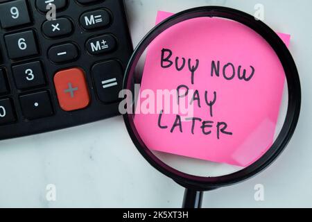 Concept of Buy Now Pay Later write on sticky notes with stethoscope isolated on Wooden Table. Stock Photo