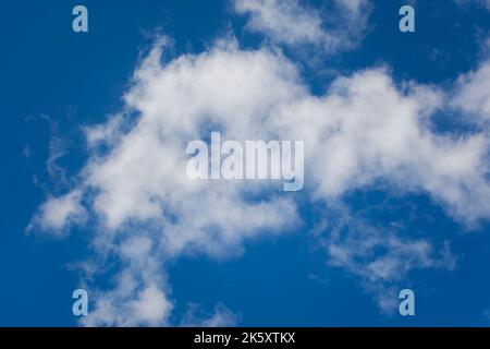 Beautiful white clouds in a blue sky. Natural atmospheric background. Fluffy snow-white clouds float high in the sky. The concept of lightness freedom Stock Photo