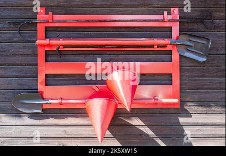Firefighter shield with fire extinguishing tools on the wall Stock Photo