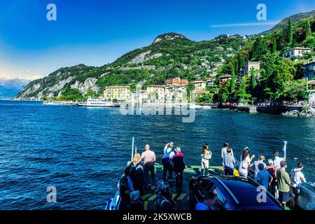A small car ferry heading towards the town of Varenna, on Lake Como, Italy. Stock Photo