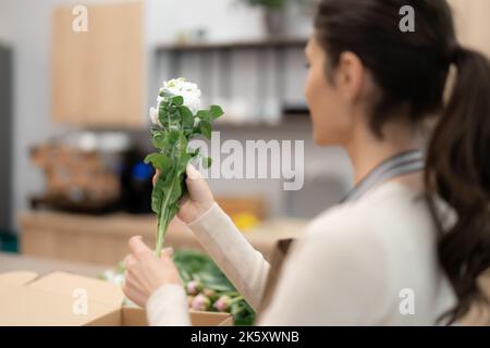 Florist working with flowers making a composition Stock Photo