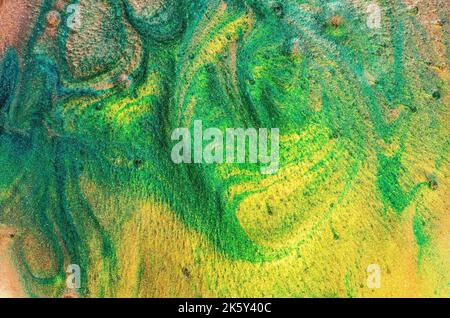 Abstract liquid. A simple and peaceful texture. A combination of green and yellow with shades of emerald green and beige.Texture of sand, soft particl Stock Photo