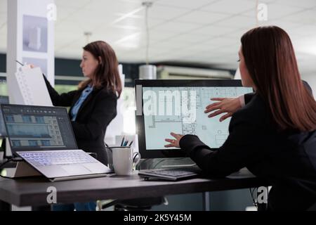 Real estate agent working in room floor planner software, using touchscreen zoom in, designing interior in 2d creator app. Cad, blueprints on computer monitor screen, designer drafting Stock Photo