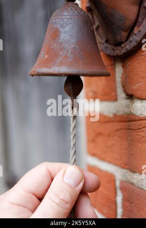 Hand ringing of old fashioned vintage door bell Stock Photo