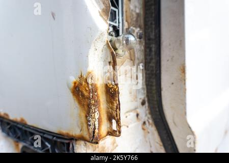 Rusty back of an old white car, minivan and no tail light close-up. Stock Photo