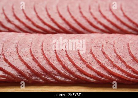 Chopped salami sausage on cutting board. Stock Photo