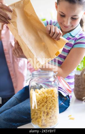 Vertical picture of mother and daughter spending time together in the kitchen Stock Photo