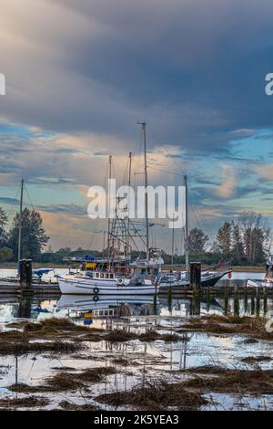 Morning clouds over docked boats at the heritage Britannia Ship Yard in Steveston British Columbia Canada Stock Photo