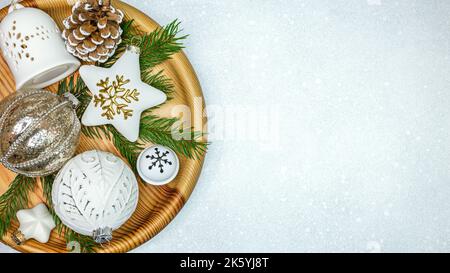 christmas decorations with stars, jingle bell and glass balls on wooden tray Stock Photo