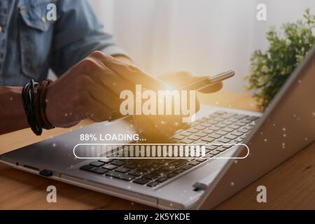 Casual Businessman Touching Mobile Phone or Smart Phone and Stick Loading Bar and Laptop Computer. Searching or Downloading Concept Stock Photo