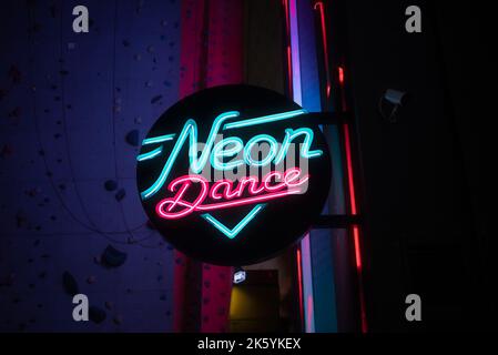 Neon dance club sign at night low angle view Stock Photo