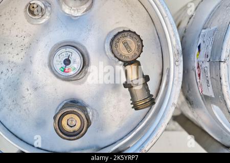 Houston, Texas USA 09-18-2022: Liquid Petroleum gas cylinders top closeup with propane level gauge and nozzle attachments. Stock Photo