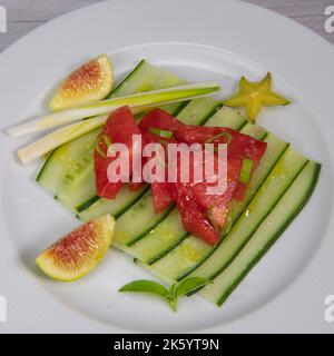 Recipe for cucumber, tomato, cebette, fig and carambola salad Stock Photo