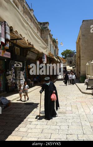 An Ethiopian Orthodox priest walking in the Christian quarter in the old city of Jerusalem. Stock Photo