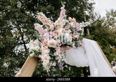 wedding ceremony area in boho style with flowers. Romantic design of a wedding arch Stock Photo