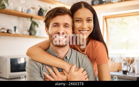 Portrait of a content interracial couple bonding together at home. Joyful mixed race girlfriend embracing her caucasian boyfriend. Happy husband and Stock Photo