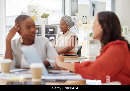 Smiling ambitious african american business woman sitting and working in office. Confident focused ethnic professional sitting behind team of Stock Photo