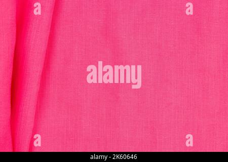 Abstract linen blend wavy fabric texture background. Pink color dyed linen textiles canvas background. Top view Stock Photo