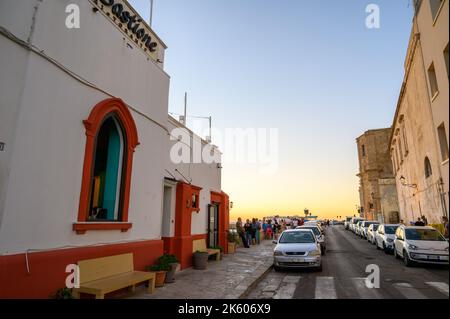 View along Riviera Armando Diaz with scores of people enjoying a beautiful sunset in early evening in old town Gallipoli, Apulia (Puglia), Italy. Stock Photo